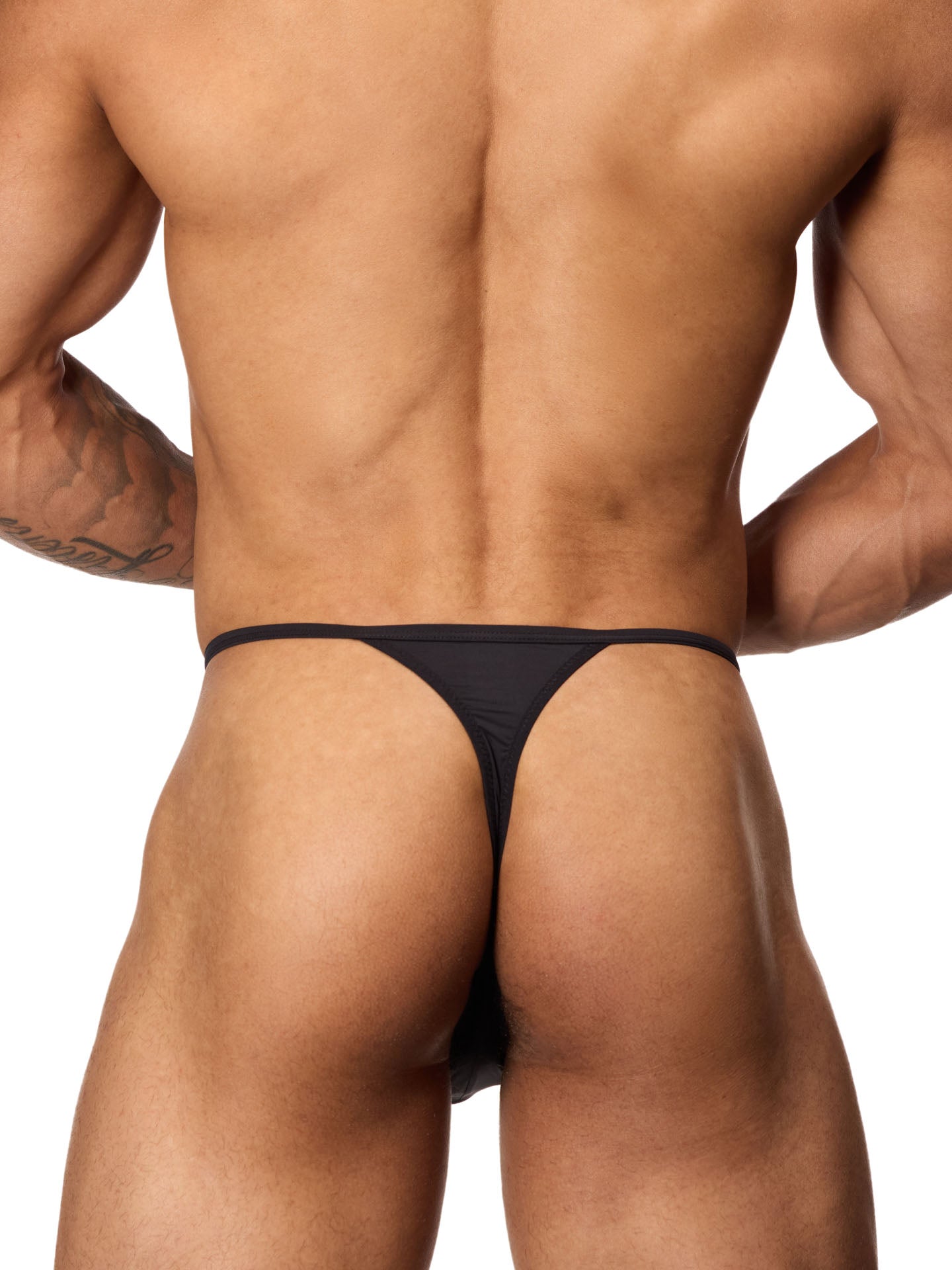 Rear view of a male model wearing a black Body Aware thong