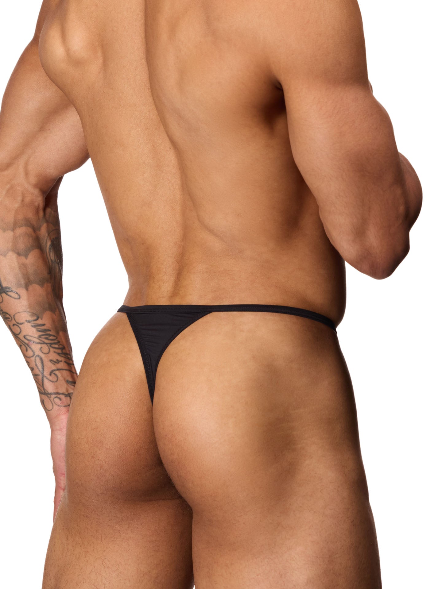 Rear side view of a male model wearing a black Body Aware thong