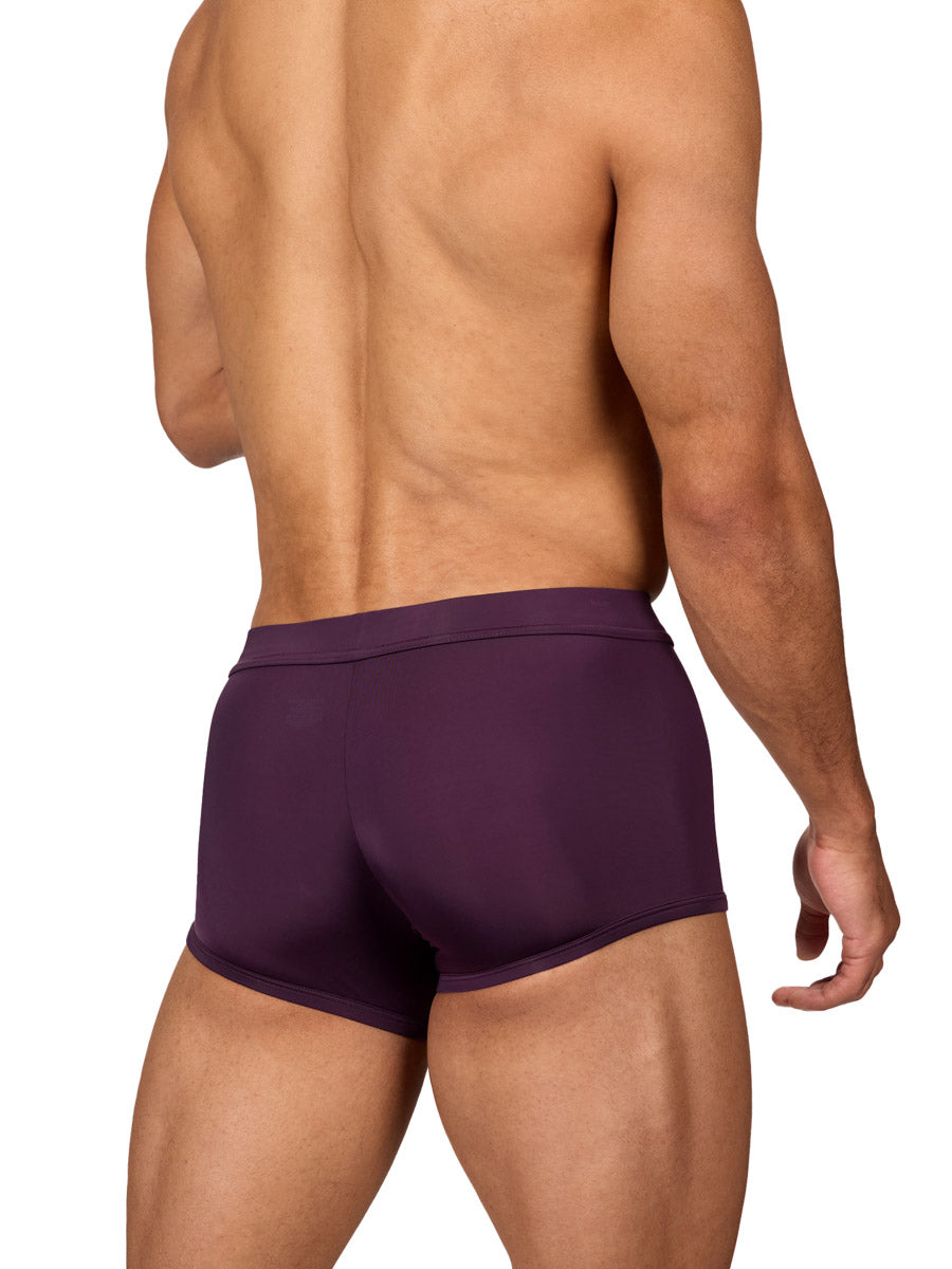 Rear view of a muscular male model wearing purple Body Aware boxer shorts