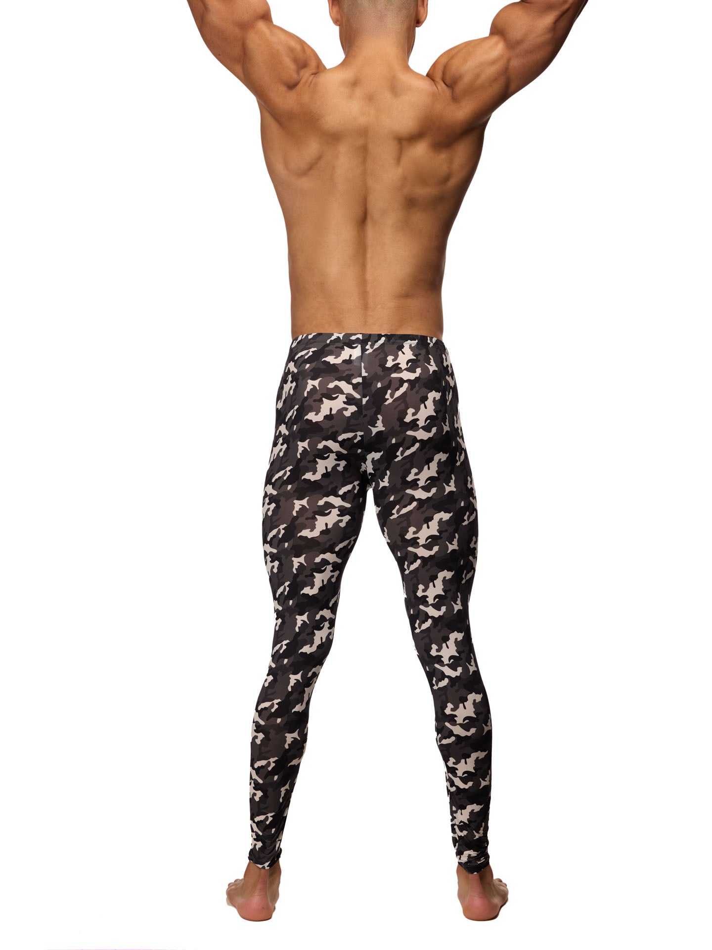 Rear view of a male model wearing black and white camouflage leggings