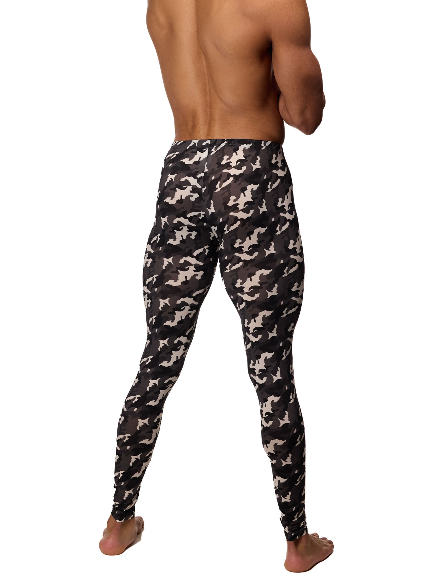 Back view of a male model wearing black and white camouflage leggings