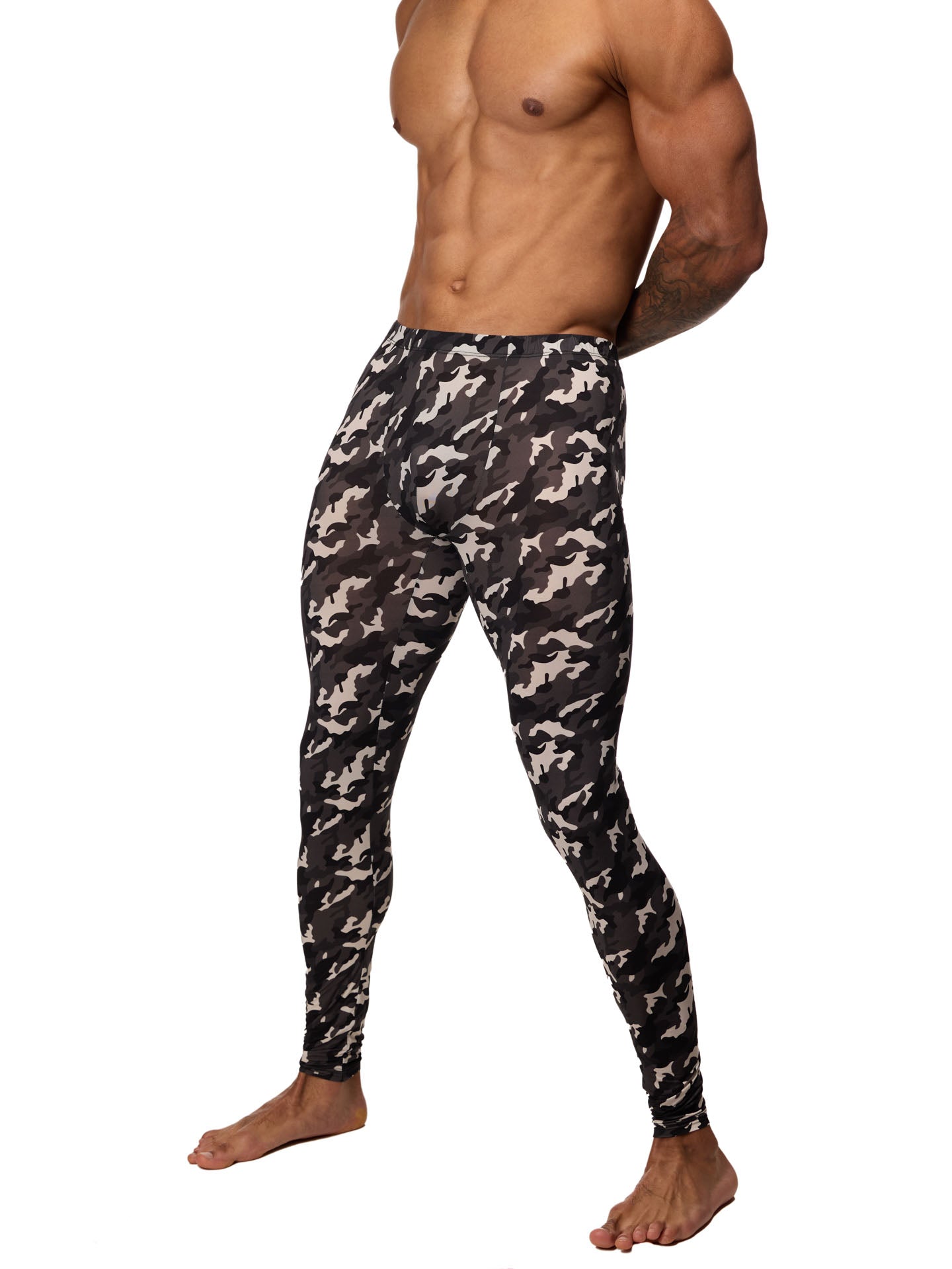 Front side view of a male model wearing black and white camouflage leggings