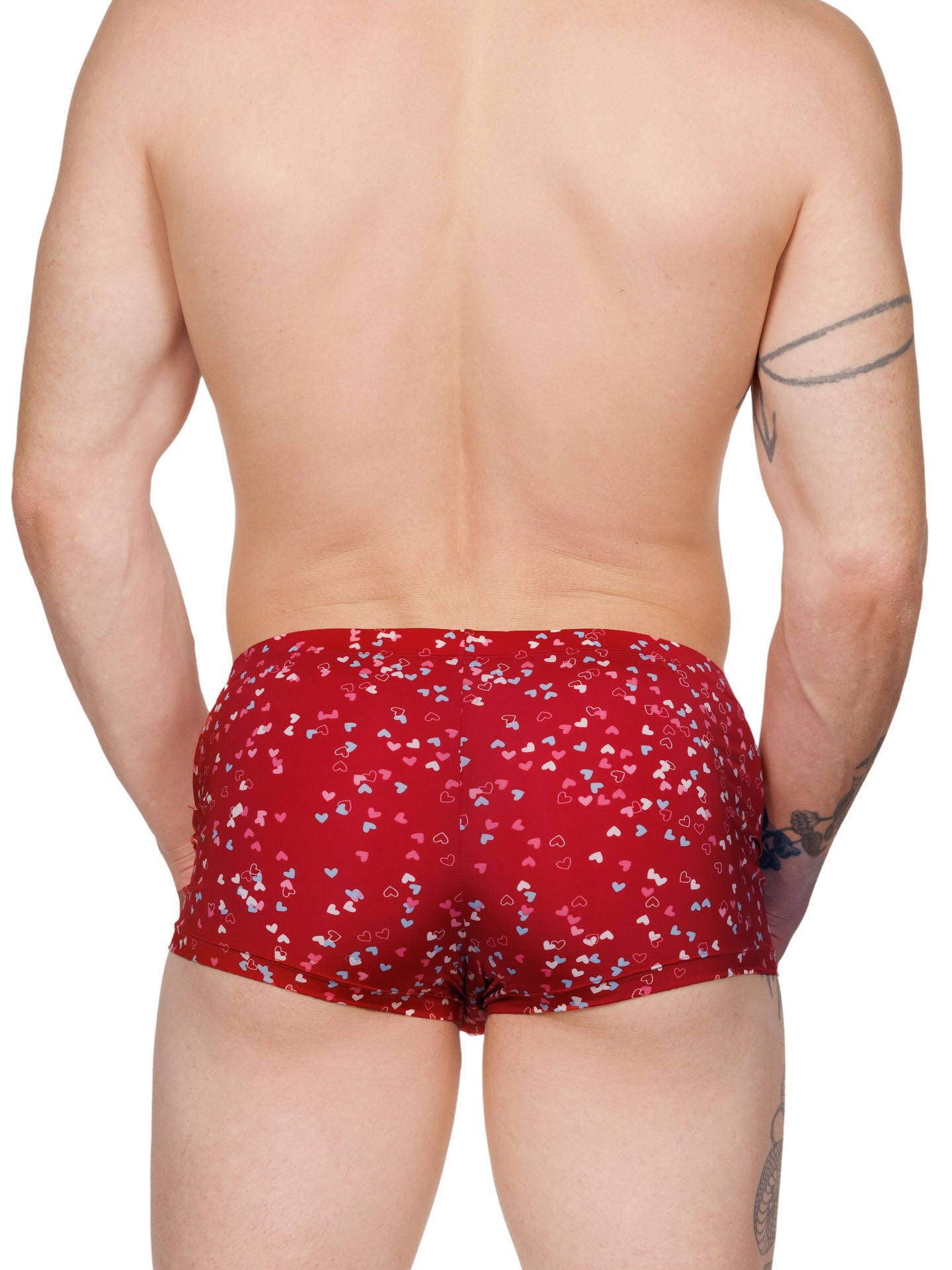 Back view of a male model wearing red Body Aware boxer shorts with a multicolor heart pattern