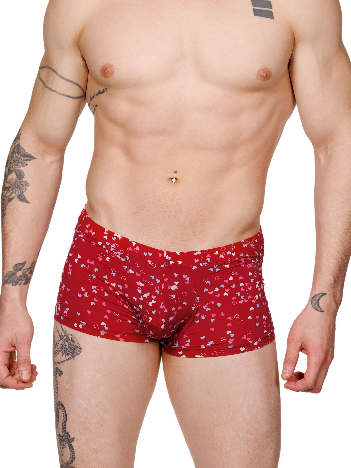 Front view of a male model wearing red Body Aware boxer shorts with a multicolor heart pattern