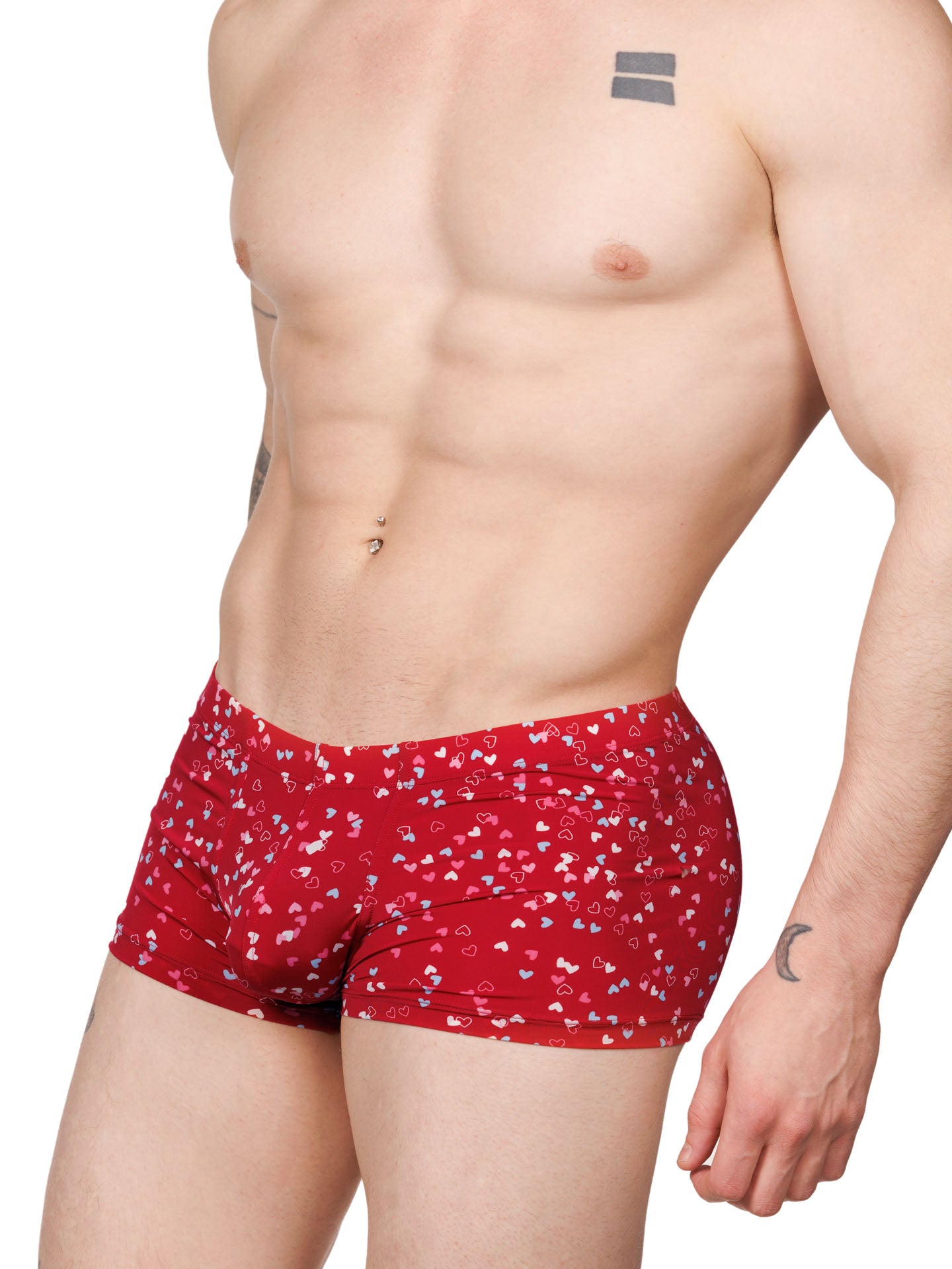 Front view of a male model wearing red Body Aware boxer shorts with a multicolor heart pattern