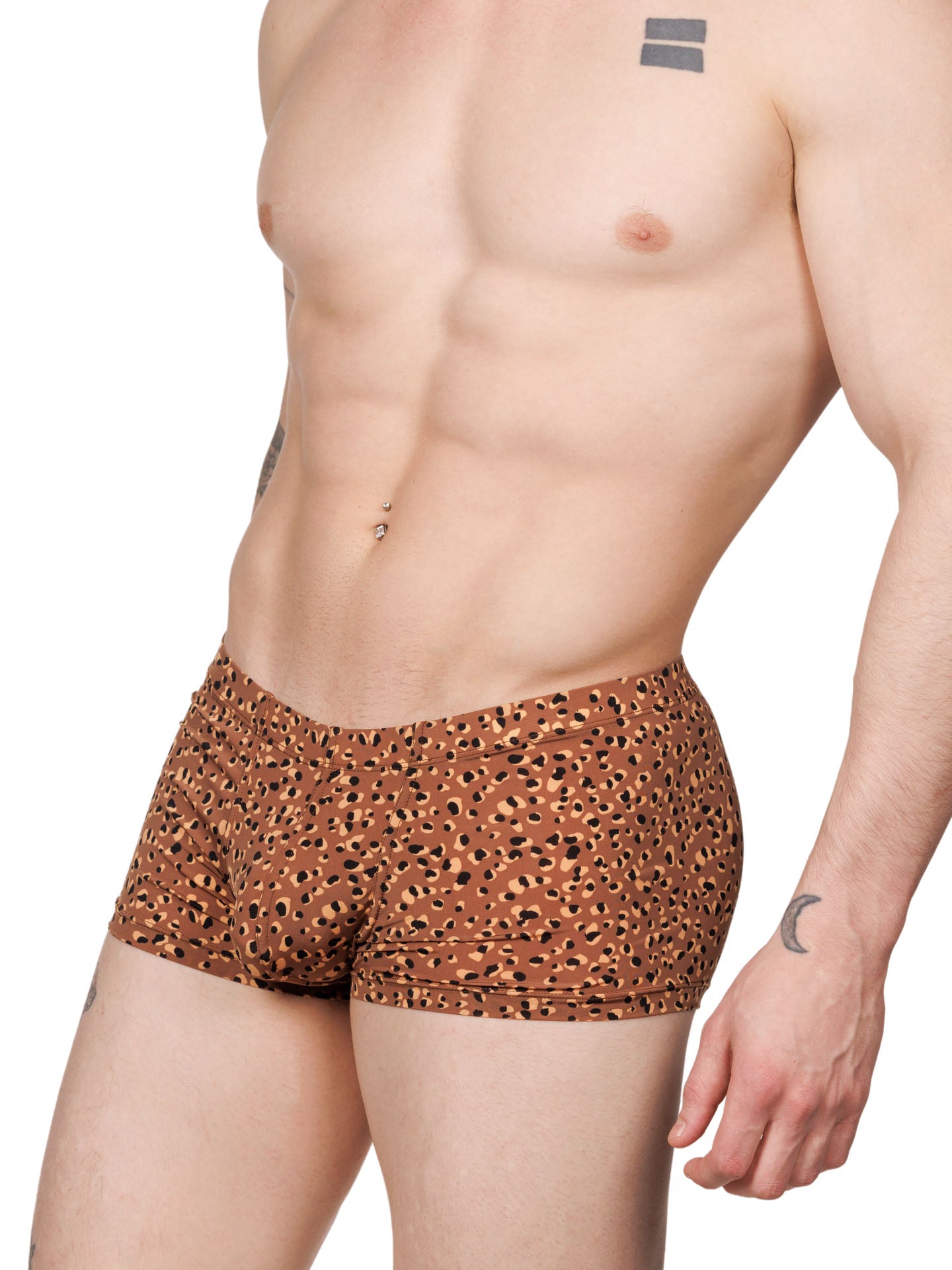 Side view of a male model wearing brown Body Aware boxer shorts with a leopard spot pattern