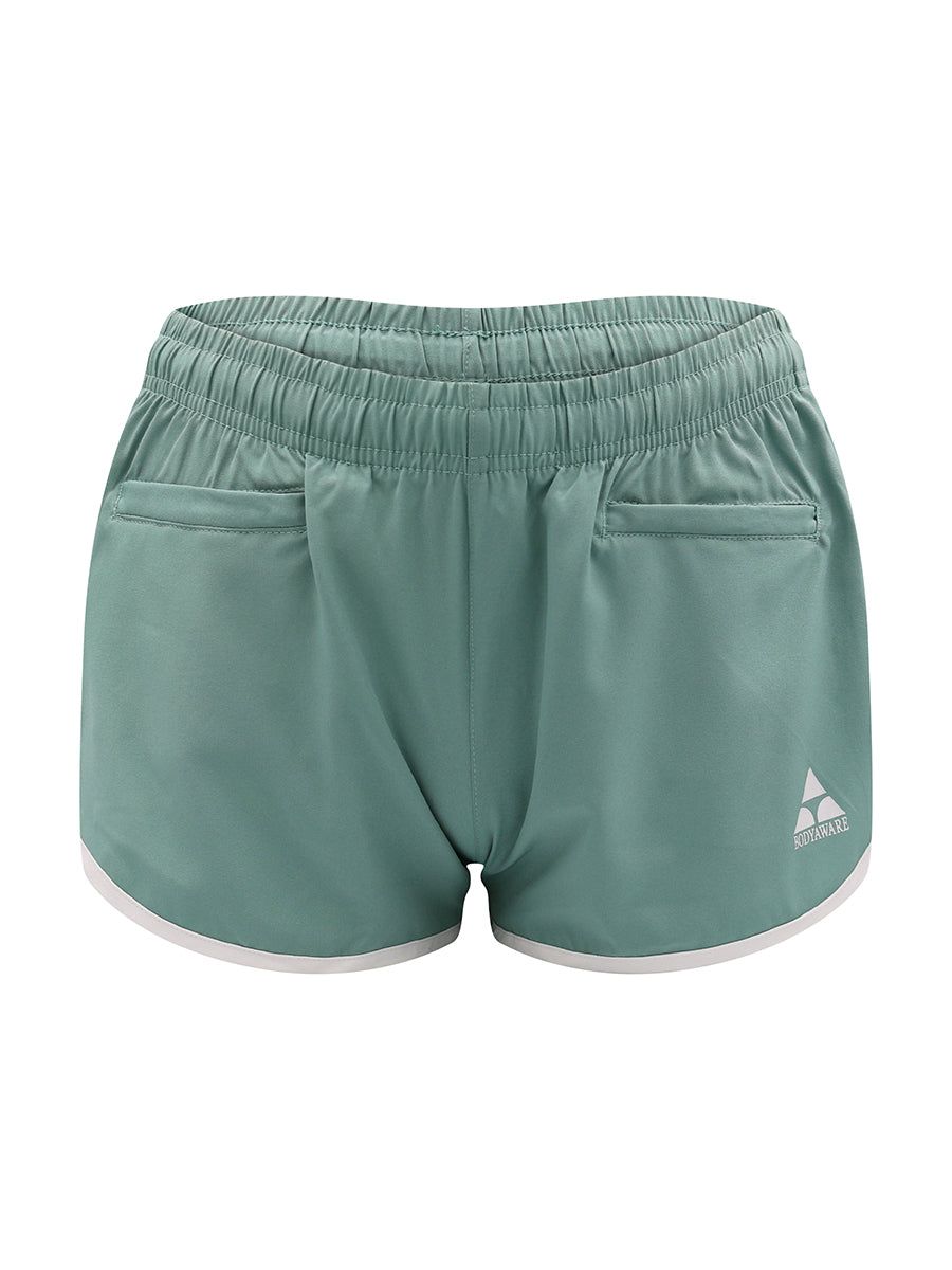 Green athletic shorts with a brand logo on a white background