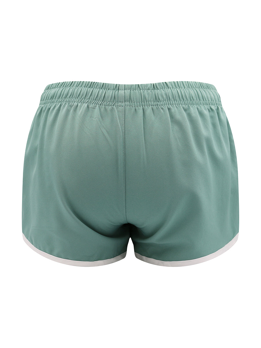 Green athletic shorts on a white background