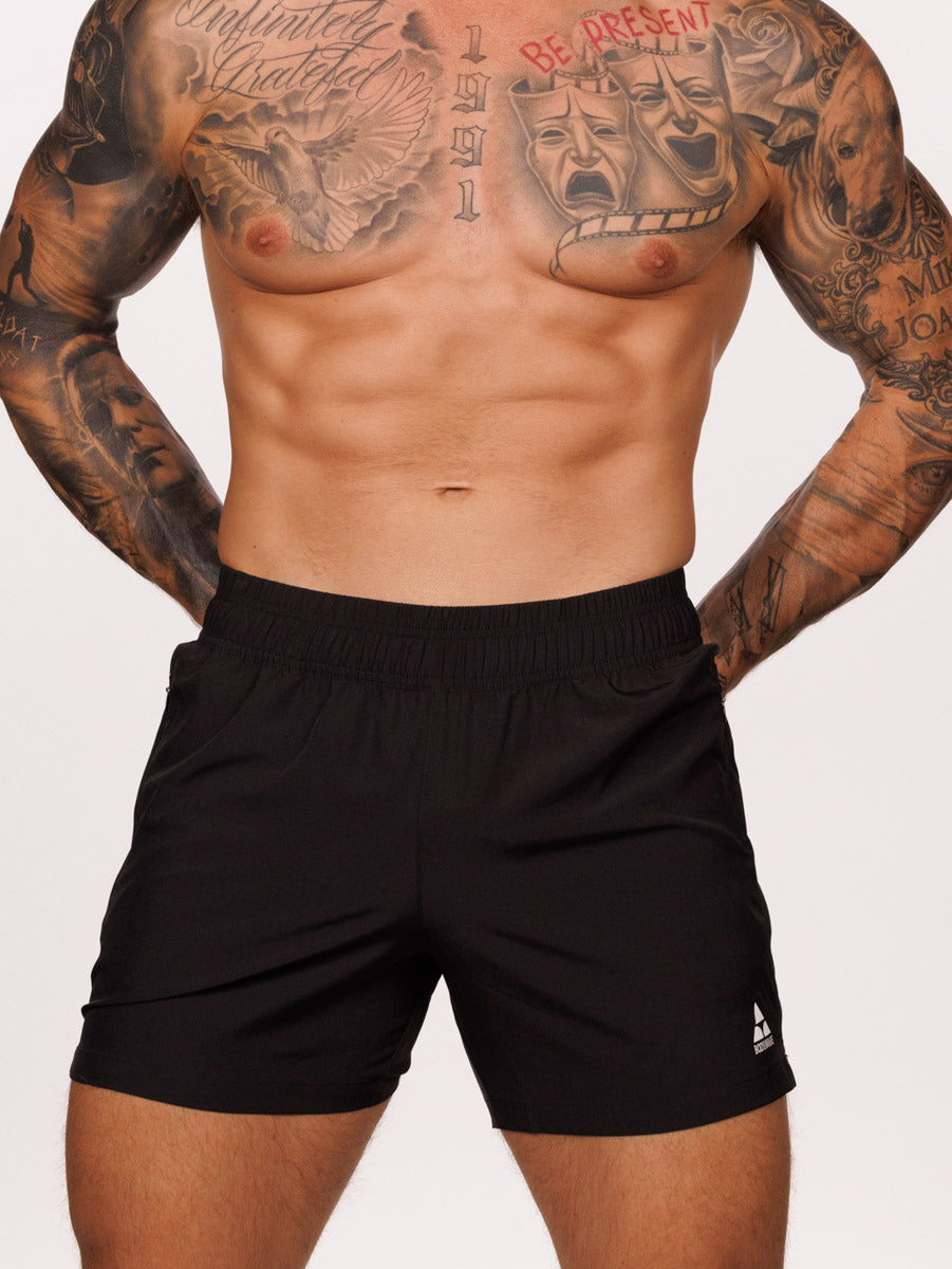 Front view of a male model wearing black Body Aware athletic shorts