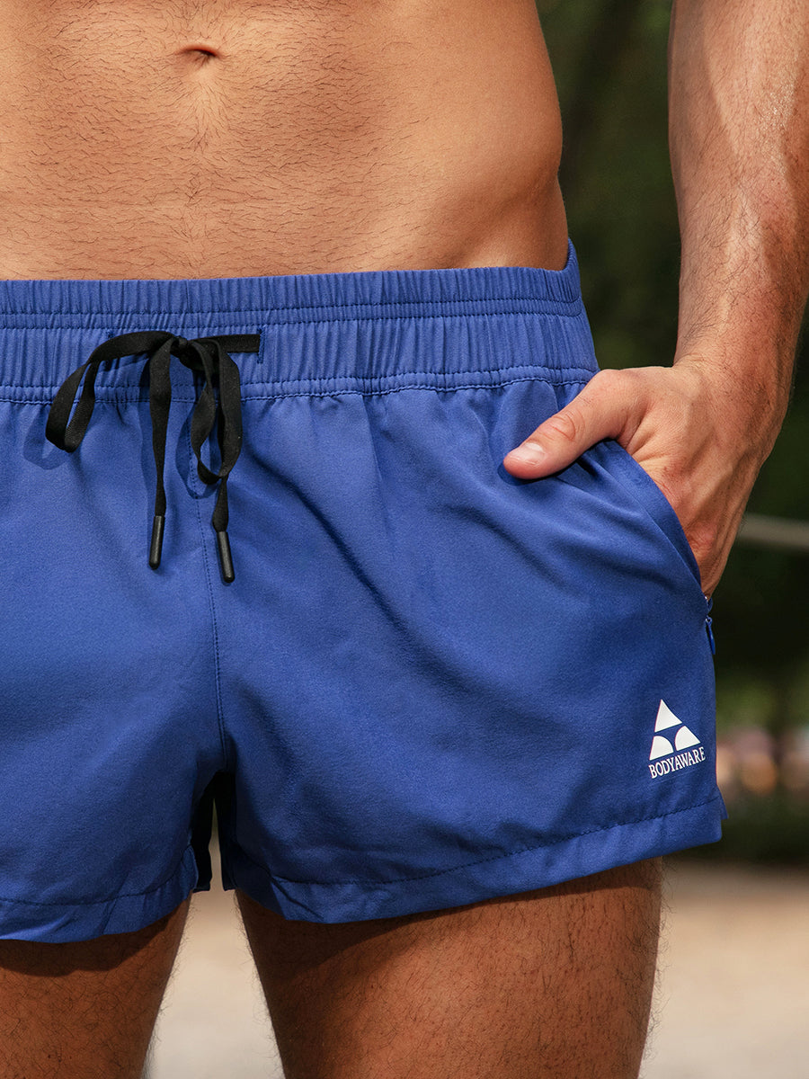Blue athletic shorts with a black drawstring and white Body Aware logo