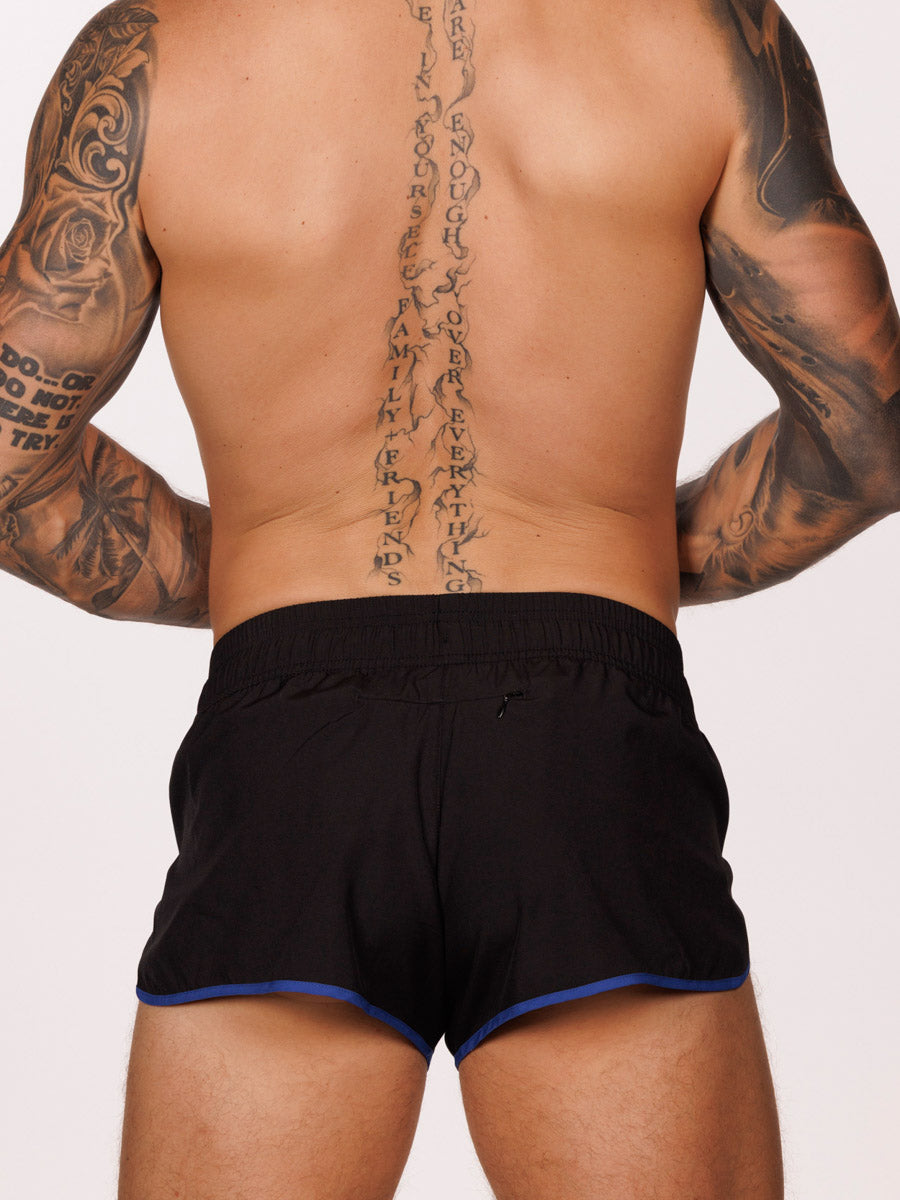 Back view of a male model wearing black Body Aware running shorts