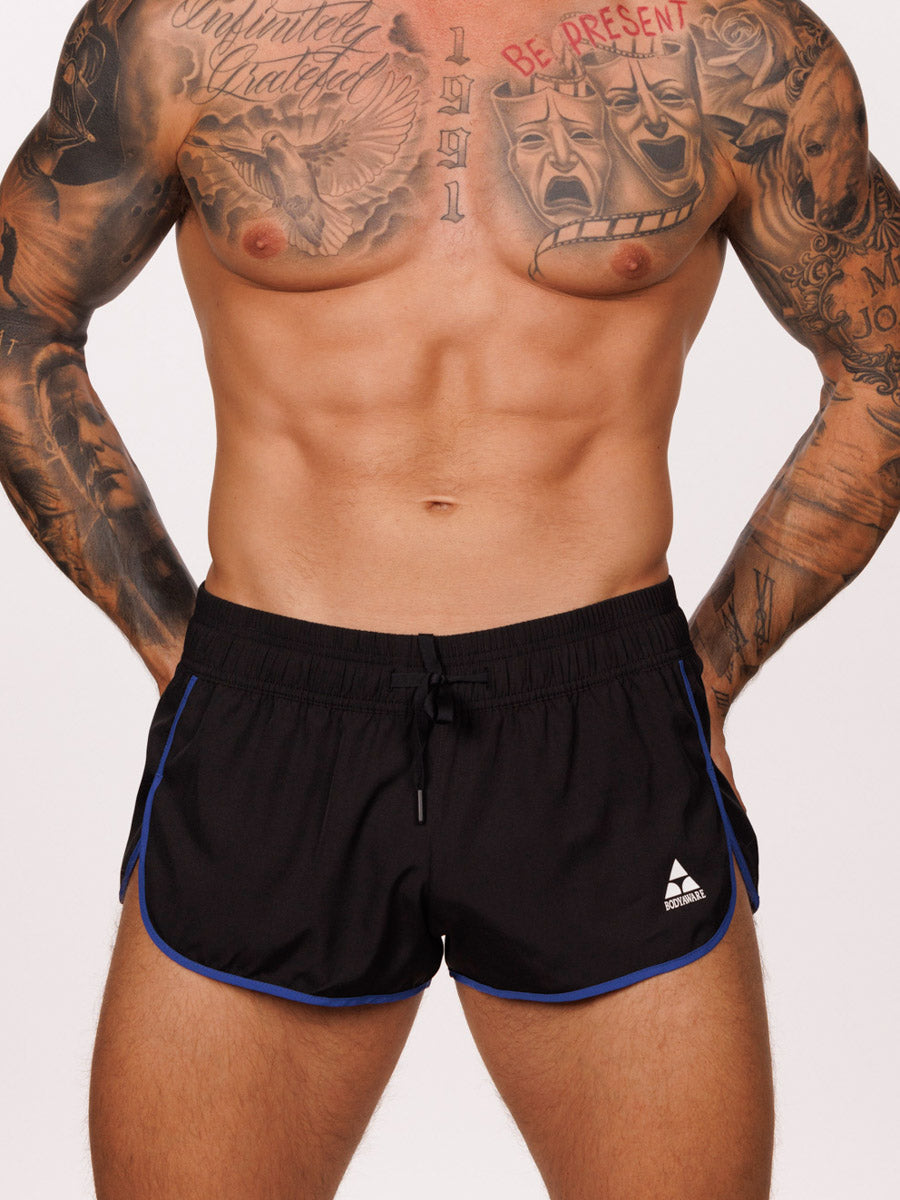 Front view of a male model wearing black Body Aware running shorts