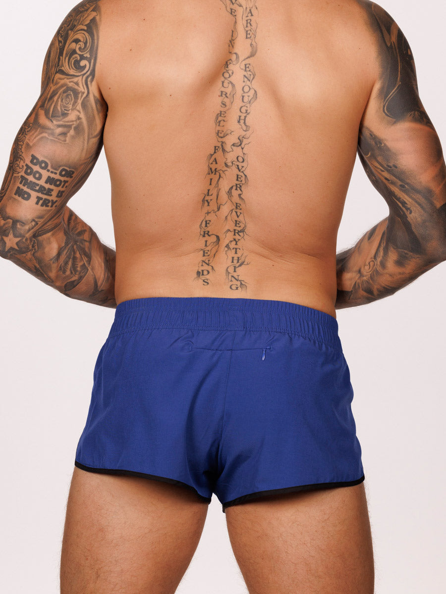 Back view of a male model wearing blue Body Aware side split shorts