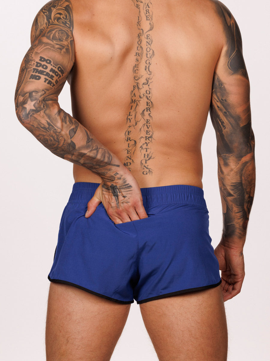 Back view of a male model wearing blue Body Aware side split shorts