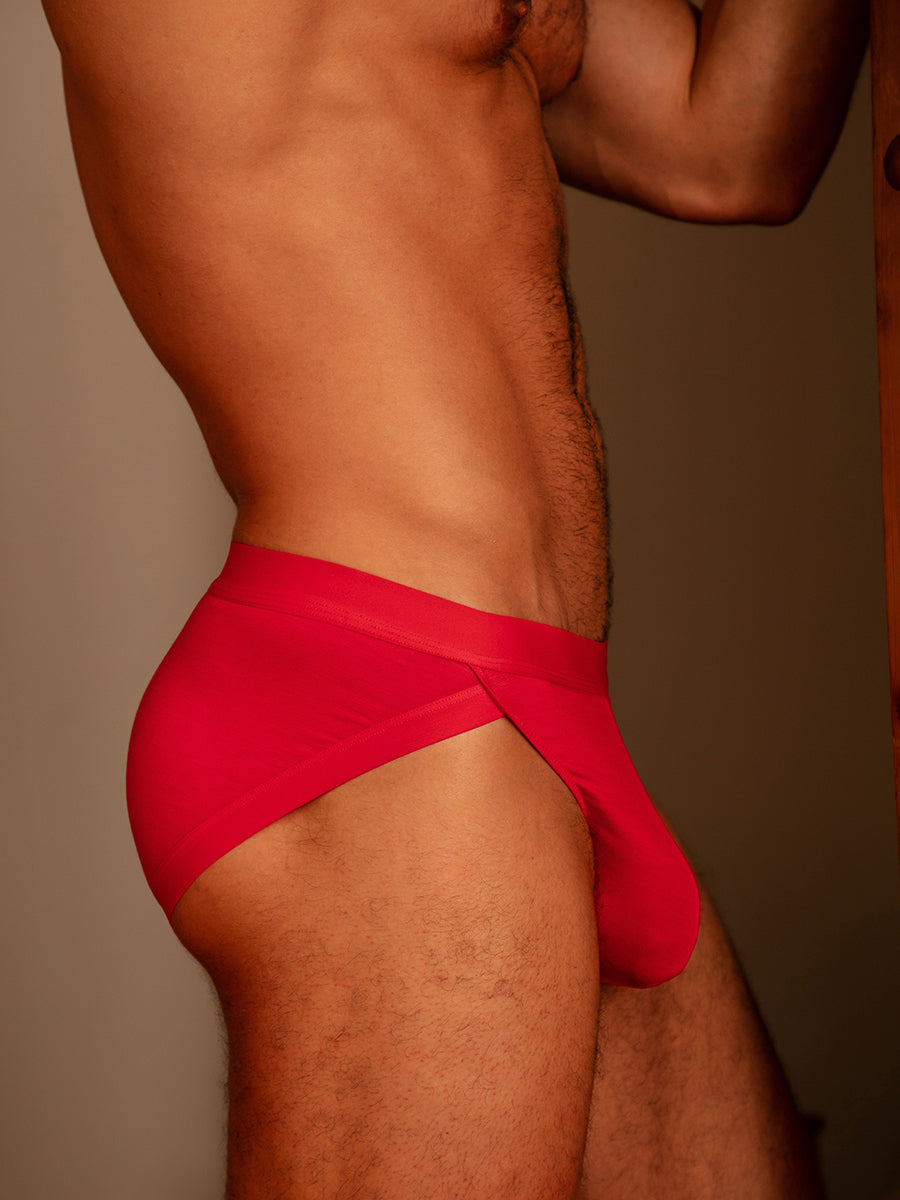 Side view of a man wearing red Body Aware briefs standing in a doorway.
