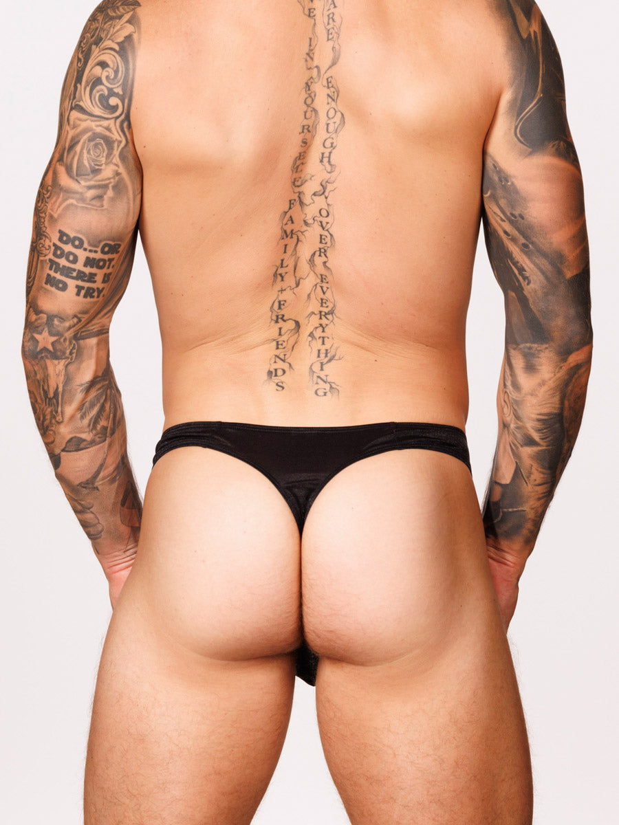 Back view of a male model wearing a black Body Aware thong