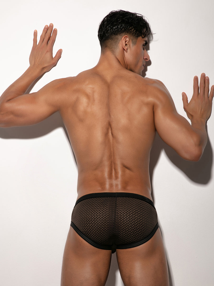 Back view of a man wearing black mesh briefs with a Body Aware waistband