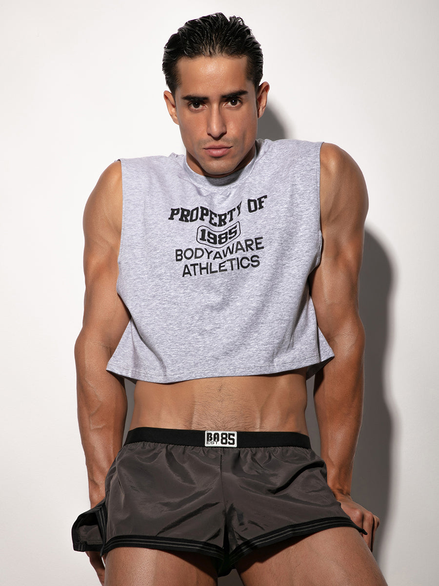 Man wearing a gray sleeveless crop top and black Body Aware shorts