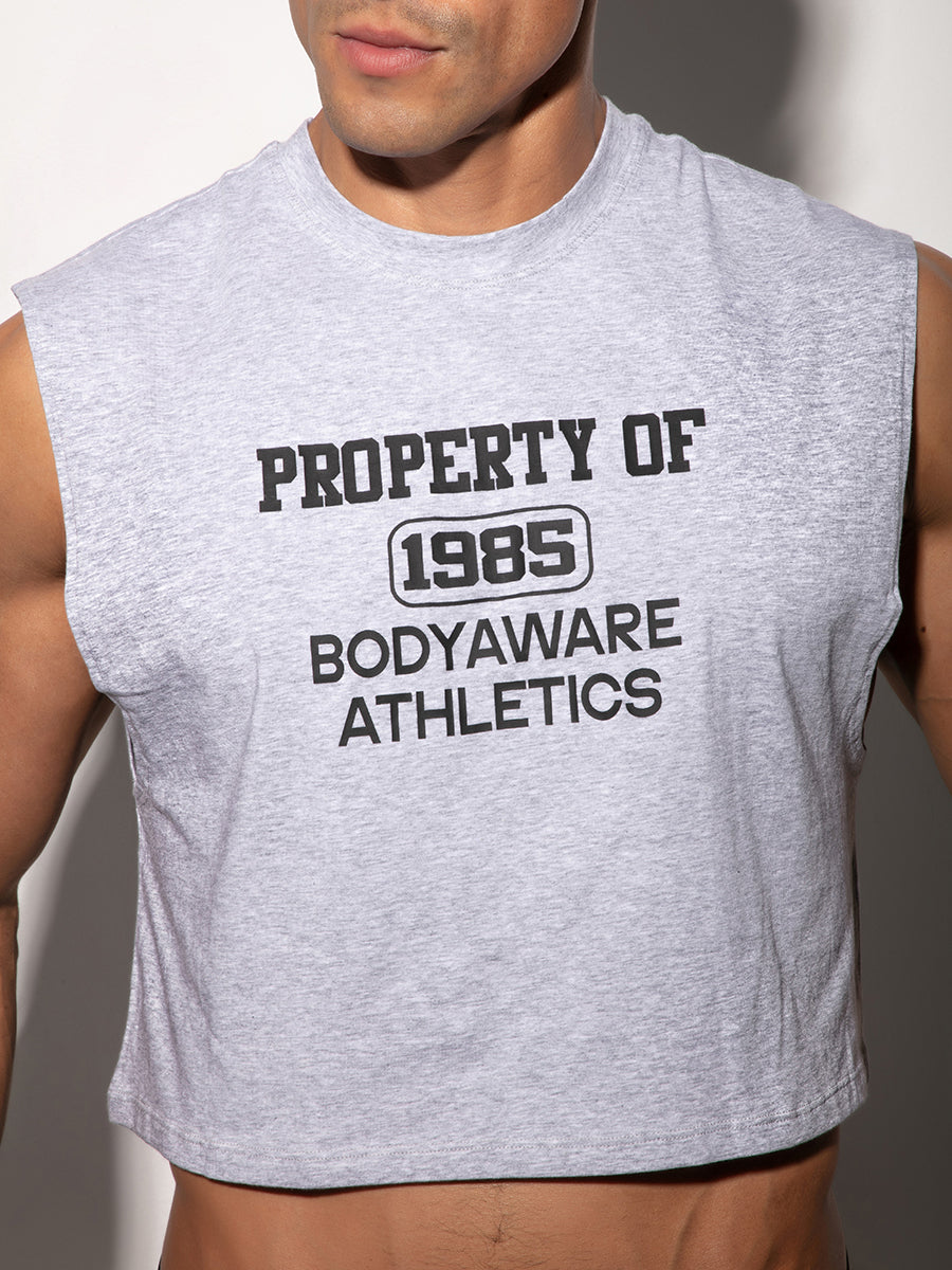 Man wearing a gray sleeveless crop top, with 'Property of Body Aware Athletics' written on the chest