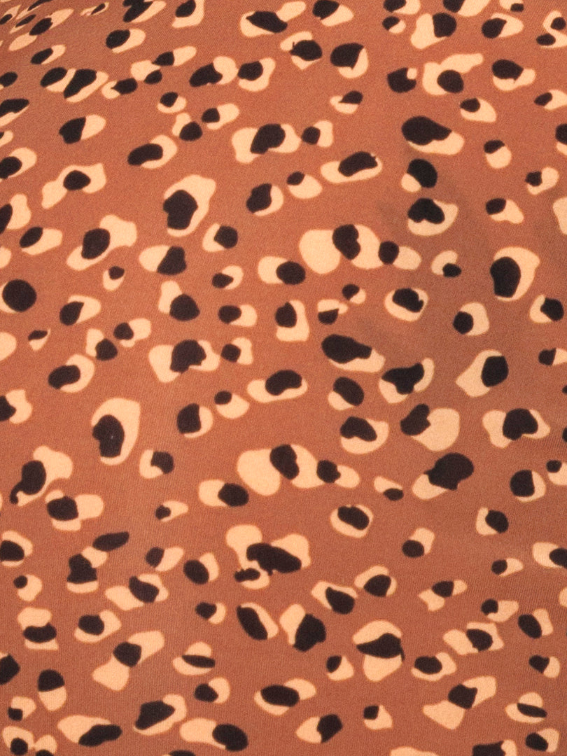 Closeup view of brown fabric with a leopard spot pattern