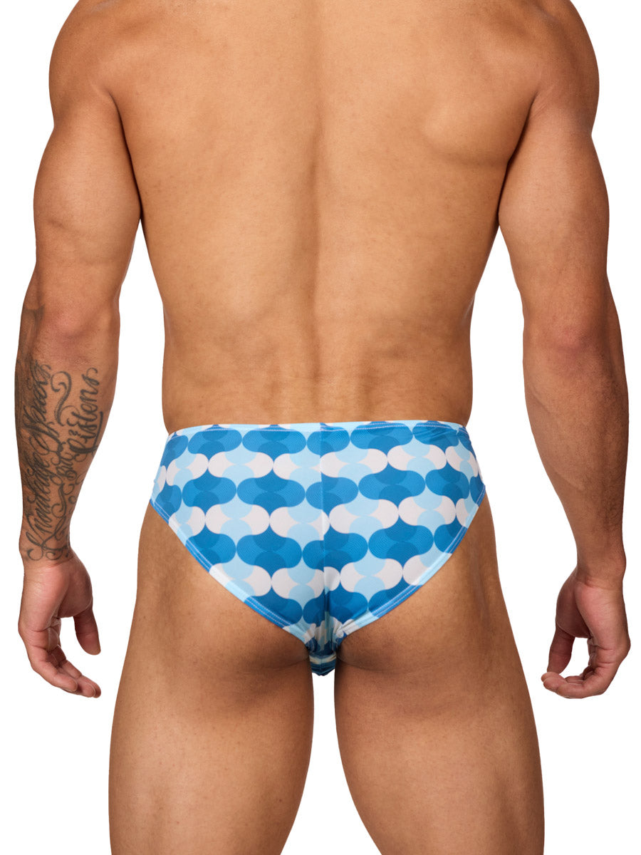 Rear view of a male model wearing Body Aware men's briefs in a blue and white wave patterned print, featuring a contoured pouch.