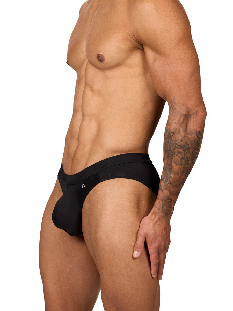 Side view of a muscular male model wearing black Body Aware briefs with matching waistband