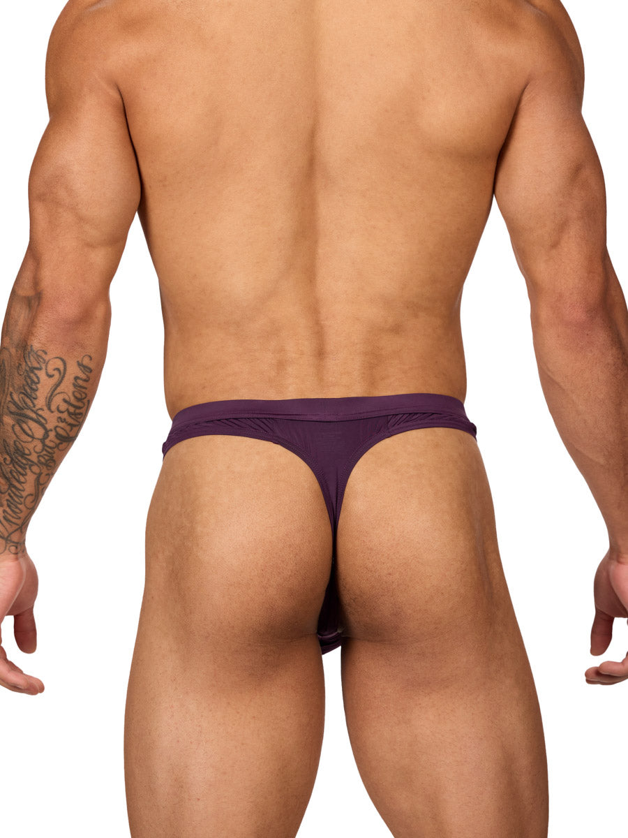 Back view of a muscular male model wearing a purple Body Aware thong with matching waistband