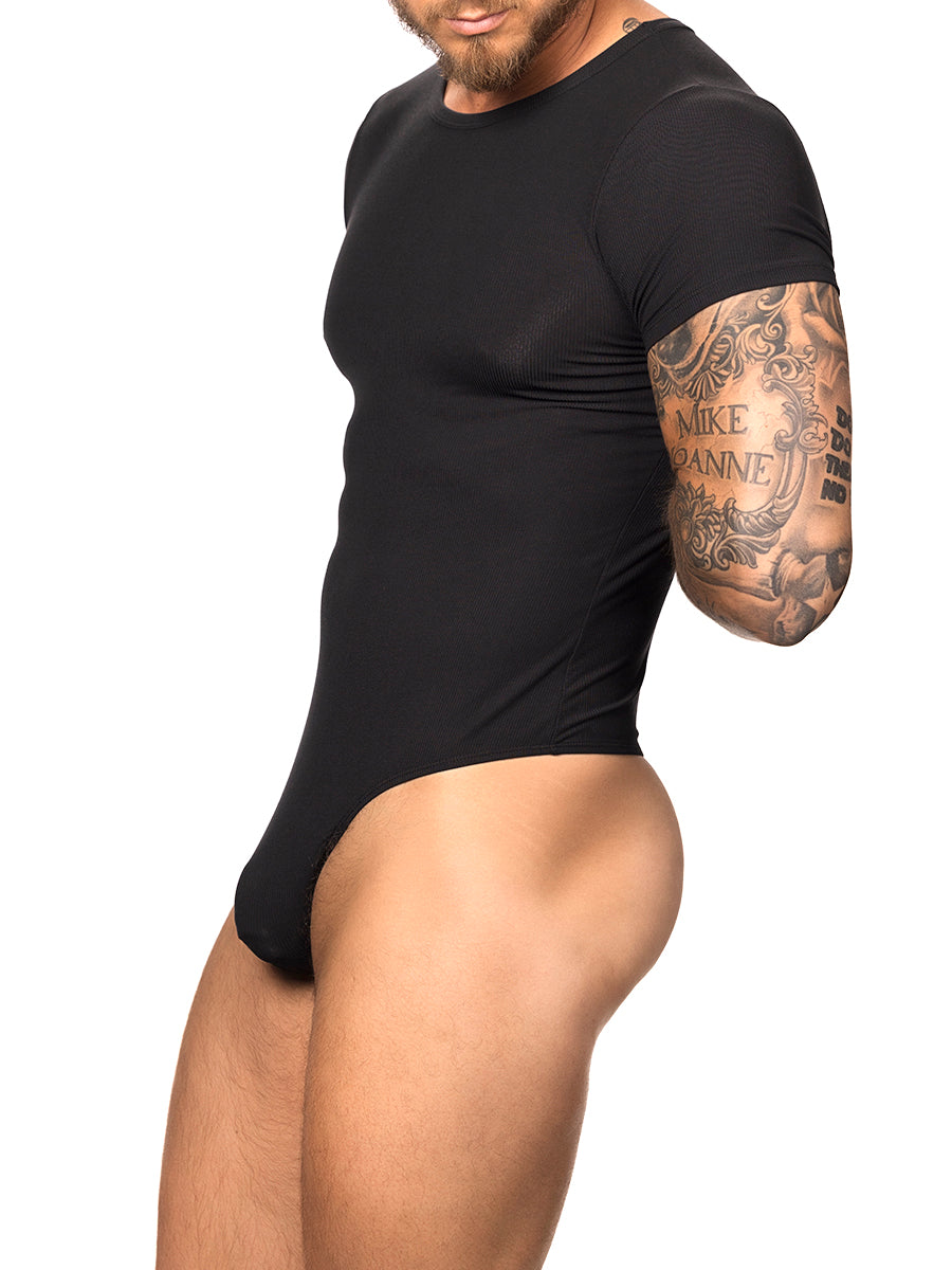 Side view of a male model wearing a black Body Aware t-shirt style bodysuit with thong back