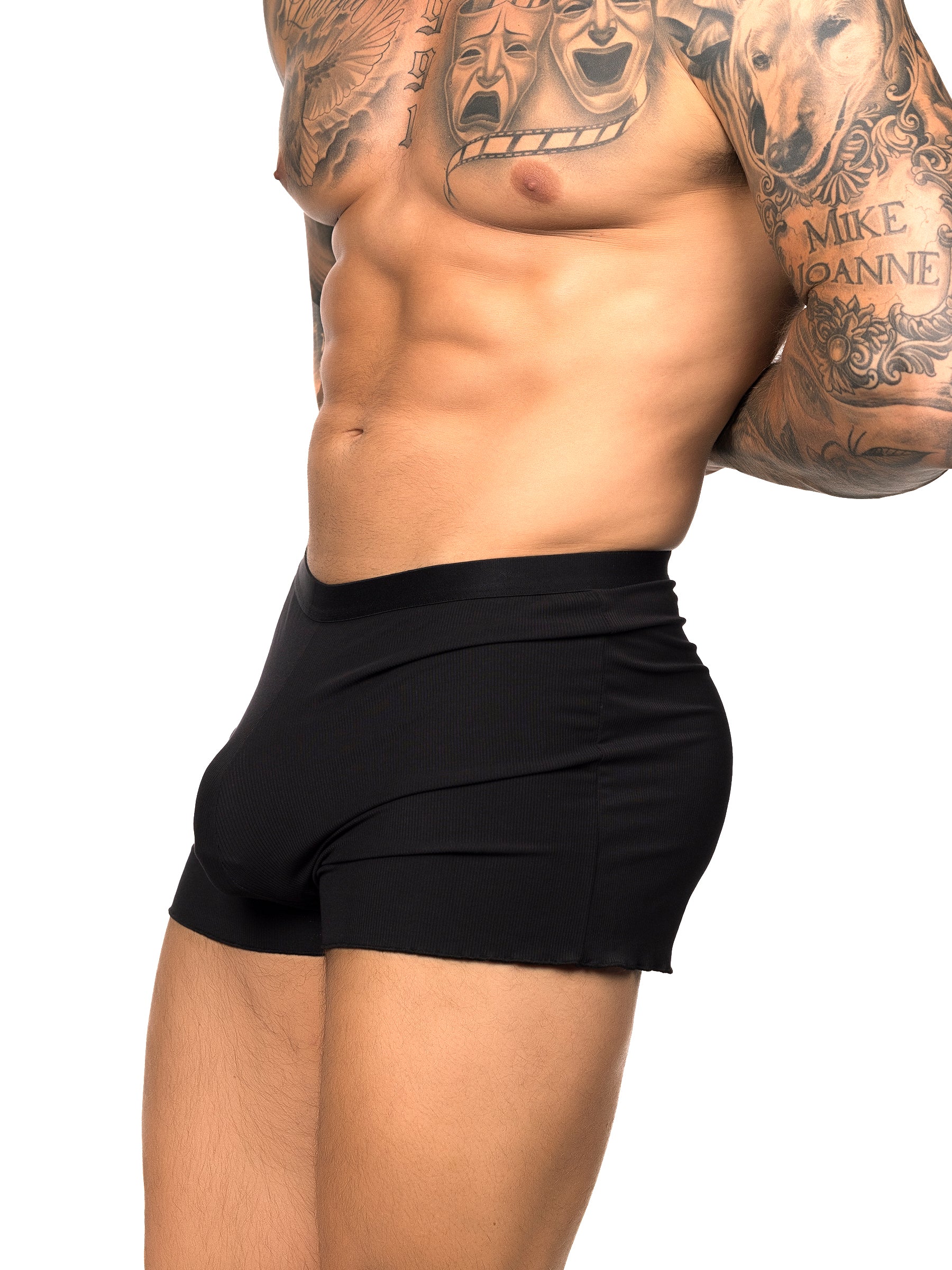 Side view of a male model wearing black Body Aware shorts