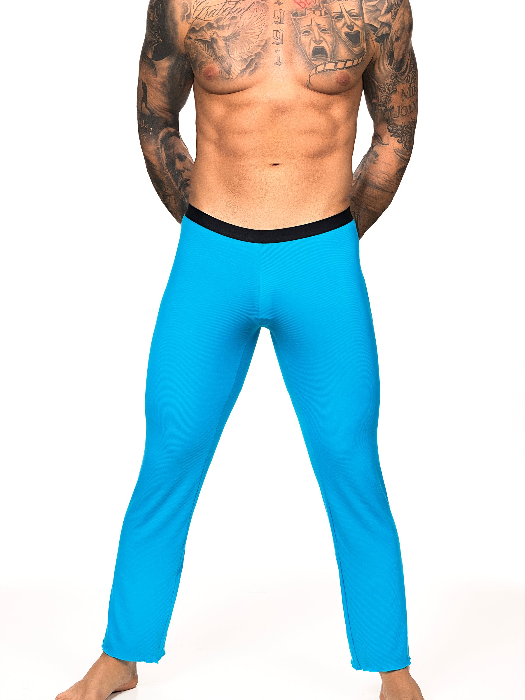 Front view of a male model wearing turquoise Body Aware lounge pants with black waistband