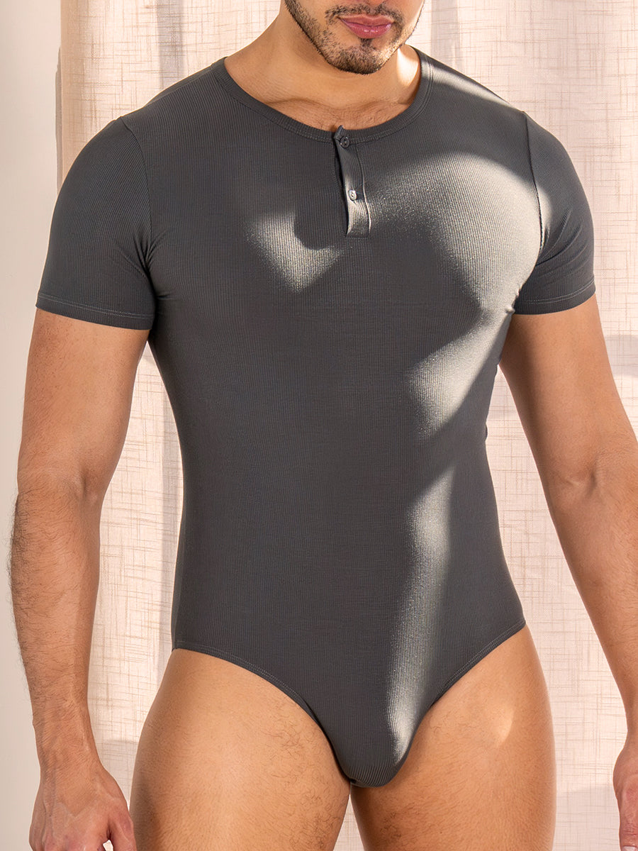 Front view of a man wearing a dark grey short-sleeve bodysuit with a henley neckline.