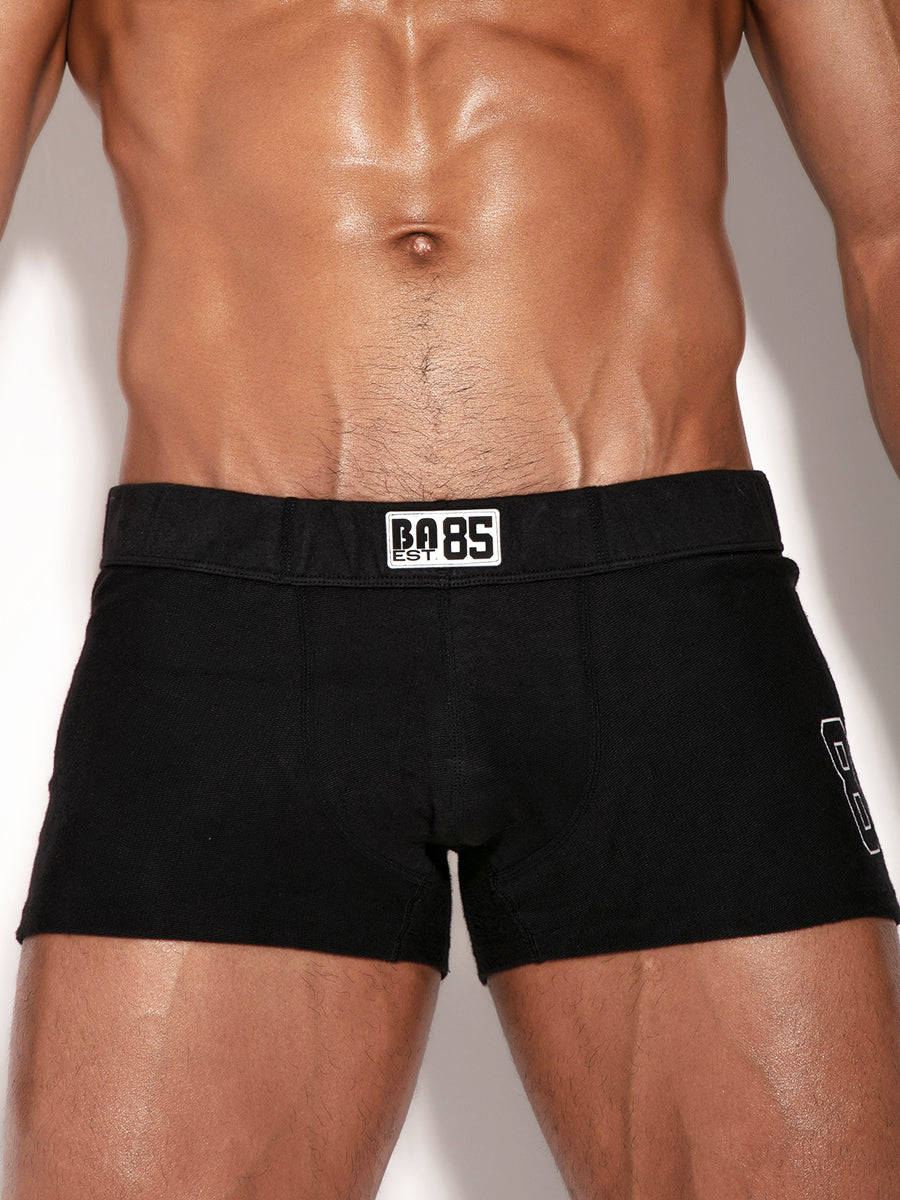 Black booty short with '85' branding on a plain background