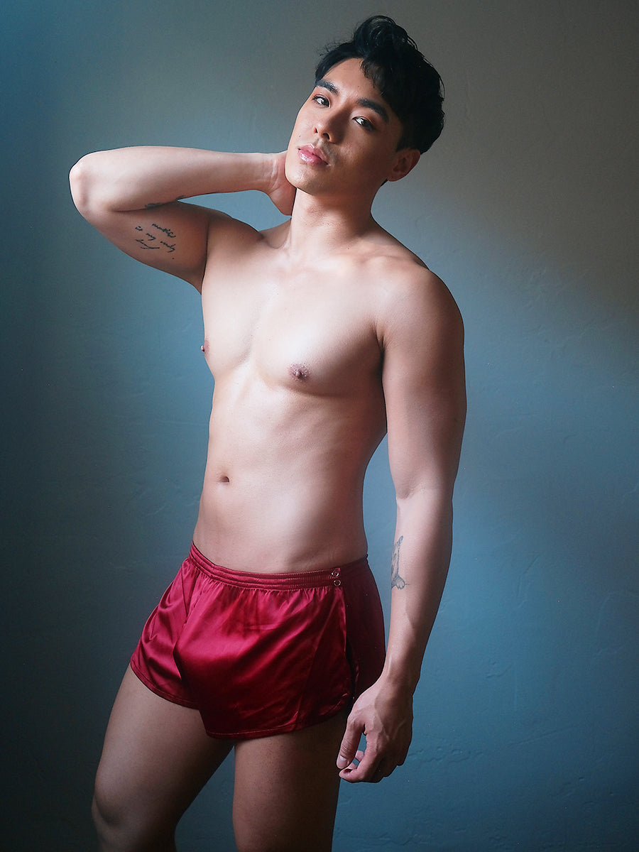 Front view of a male model wearing Body Aware red men's tear away shorts