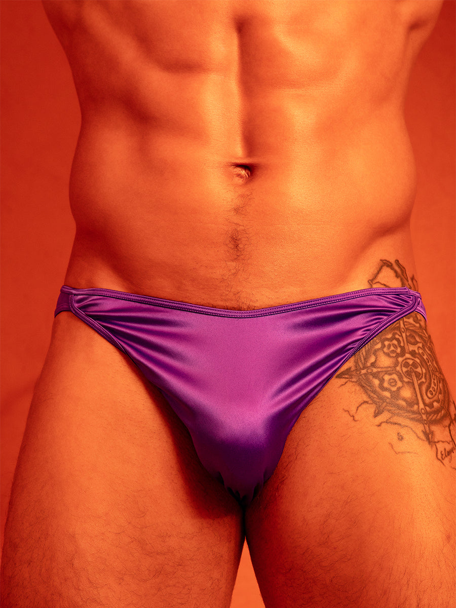 Closeup front view of a man wearing purple satin underwear briefs.