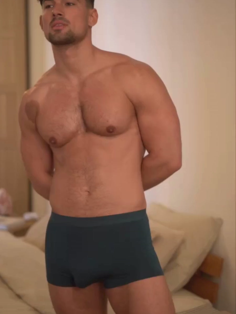 Video of a man wearing teal green Body Aware boxer shorts.